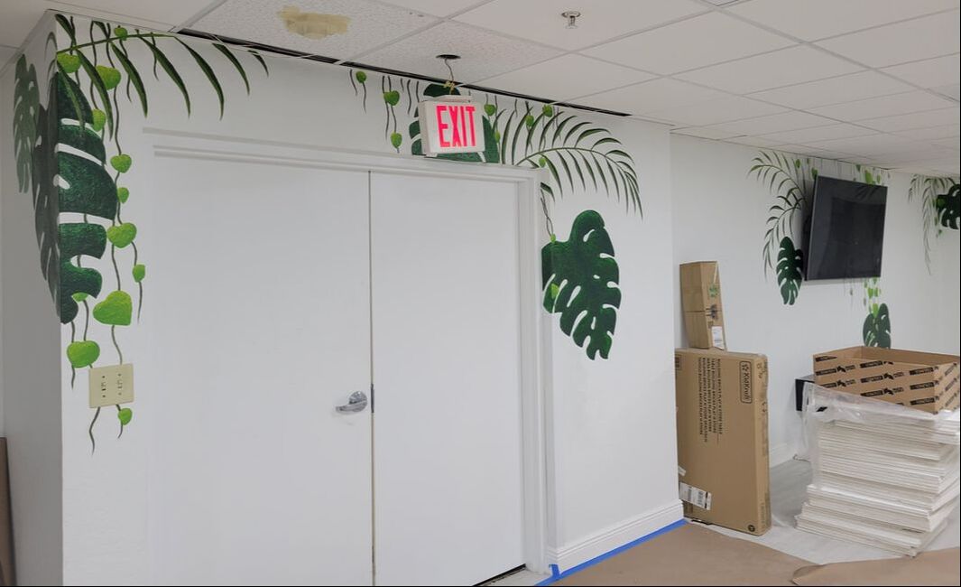 mural of tropical palms and monstera leaves 