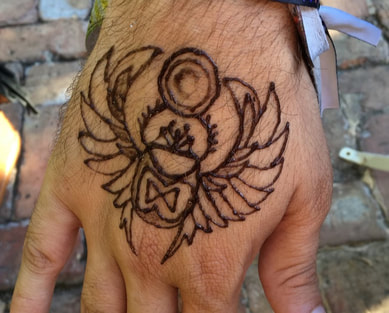 Men henna hand tattoo of Egyptian scarab